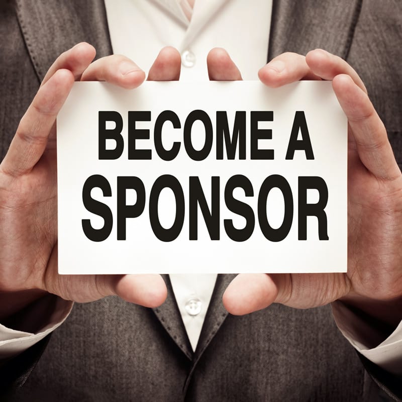 Man holding a sign that reads, "Become a Sponsor" encouraging Practicum Sponsorship from organizations to help Engineering management students at NC State University