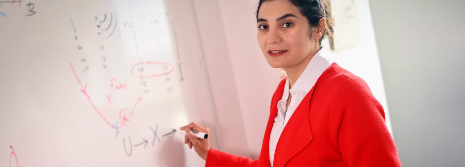 ISE assistant professor Sara Shashaani writing on a whiteboard