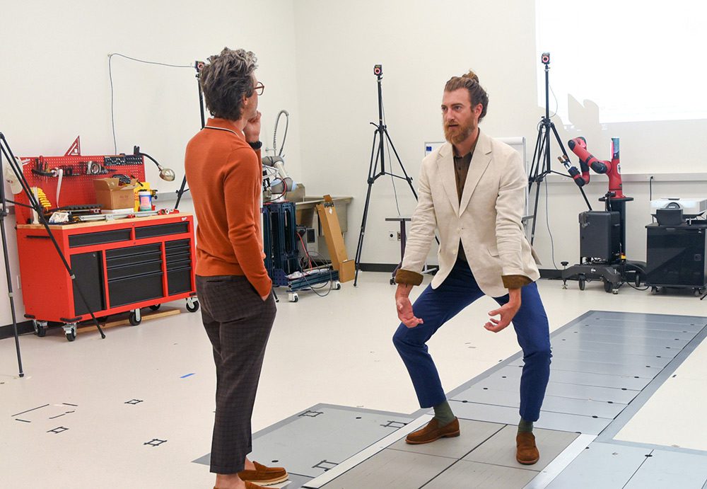 Rhett & Link in the Biomechanics Lab with Rhett lifting a virtual box