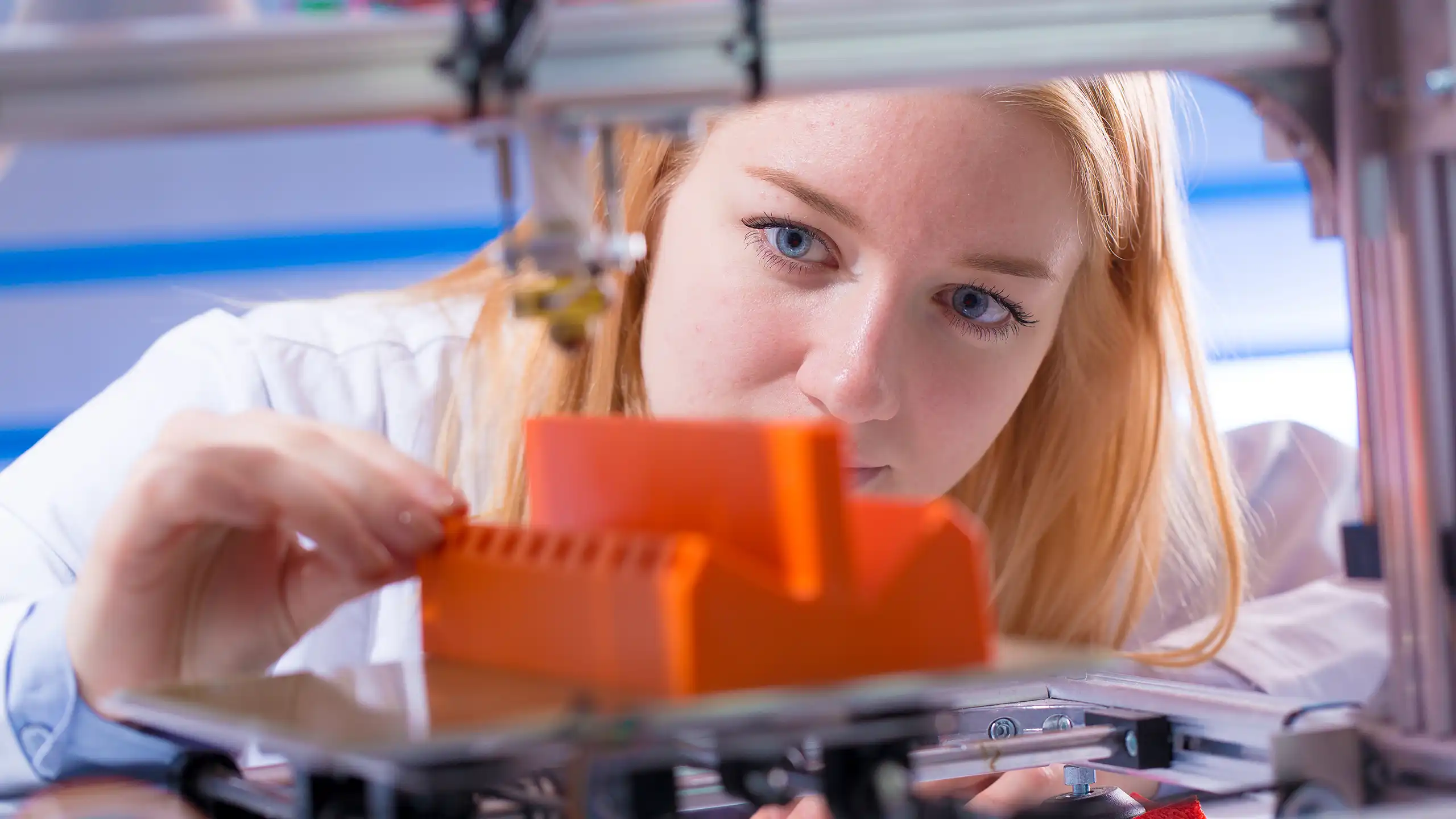 A student using a 3D printer in an advanced manufacturing class as part of their Master of Engineering Management at NC State University.