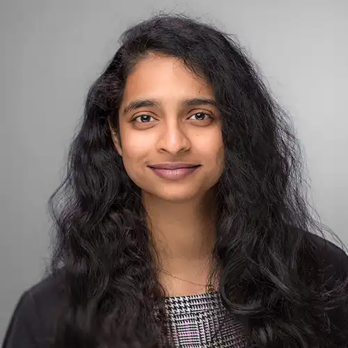 A headshot of MEMtor Alekhyaa Nelluri standing in front of a light gray background.