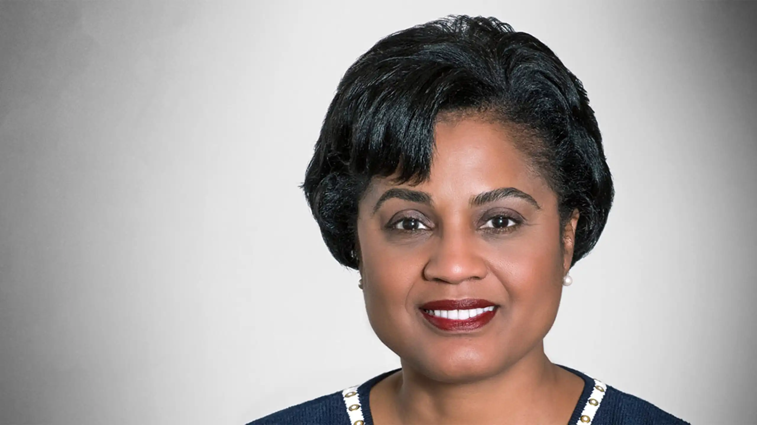 A headshot of Gayle Lanier standing in front of a white background.