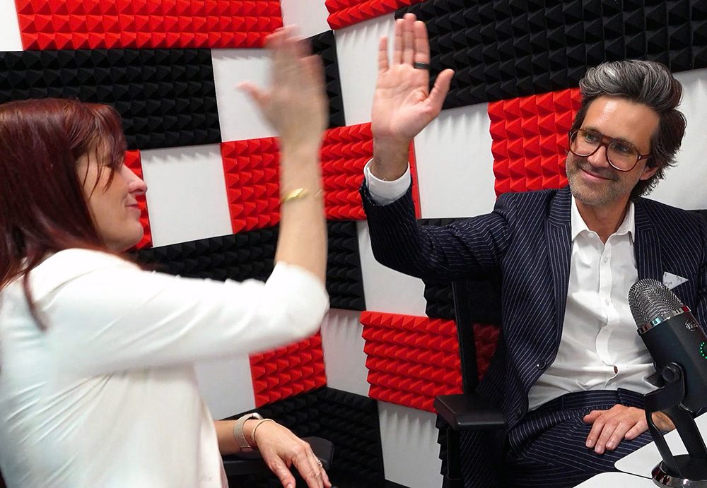 Julie Swann and Link Neal high fiving in a recording studio