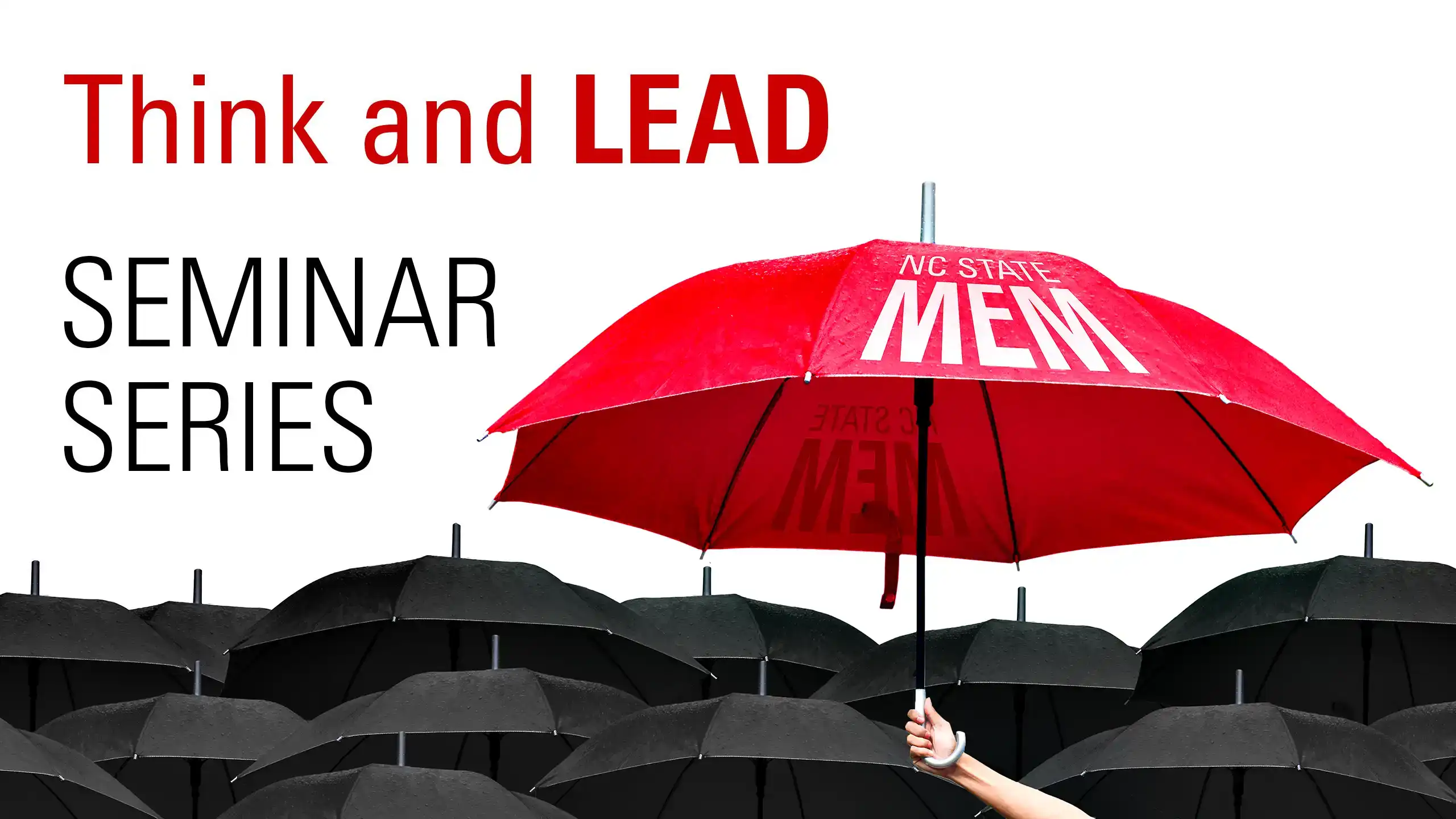 A large red umbrella with the words "NC State MEM" printed on it heard above a sea of smaller black umbrellas. In the background are the words Think and Lead Seminar Series.