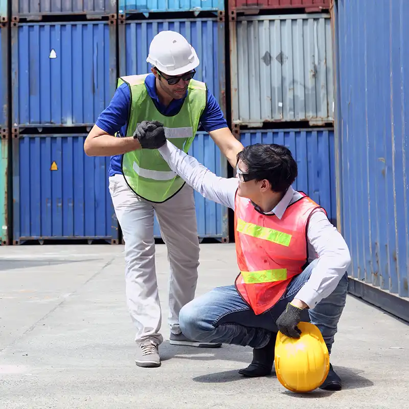 A student showing a client how to safely perform a physical task as part of his Health and Human Systems Engineering Concentration for his Master of Engineering Management degree at NC state University.