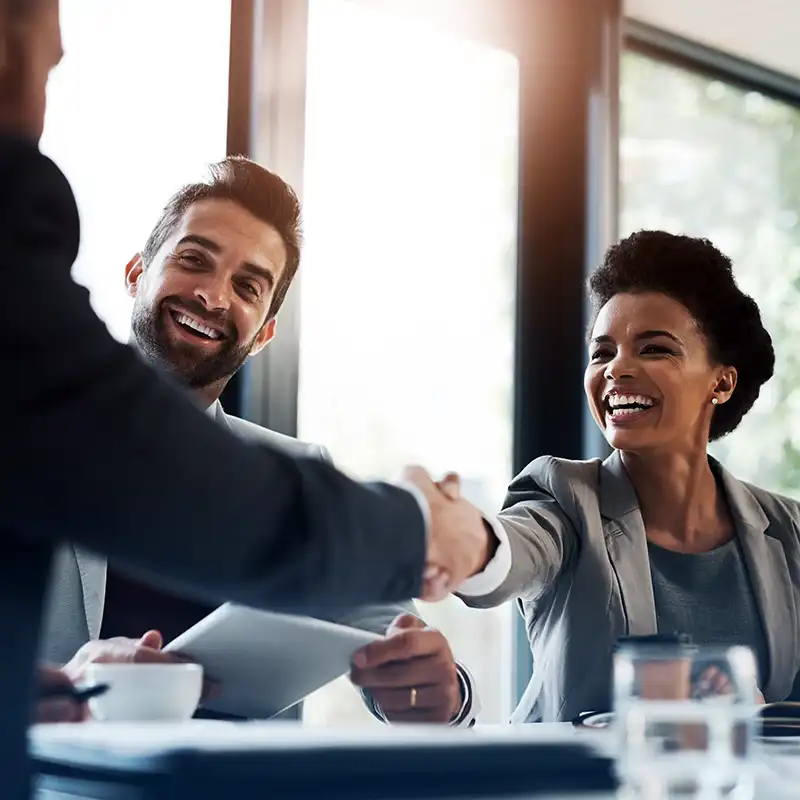 A student shaking hands with industry partners as she begins working as part of her Engineering Management degree from NC State University.