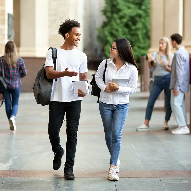 Two students walking on-campus to one of their Master of Engineering Management classes.