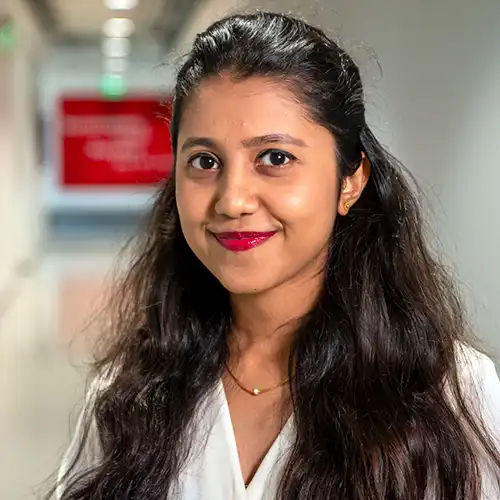 A headshot of MEMtor Sanjana Rao standing in a hallway within FItts-Woolard Hall.