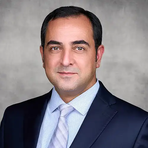 A headshot of Mohammad Hossein standing in front of a light gray background.