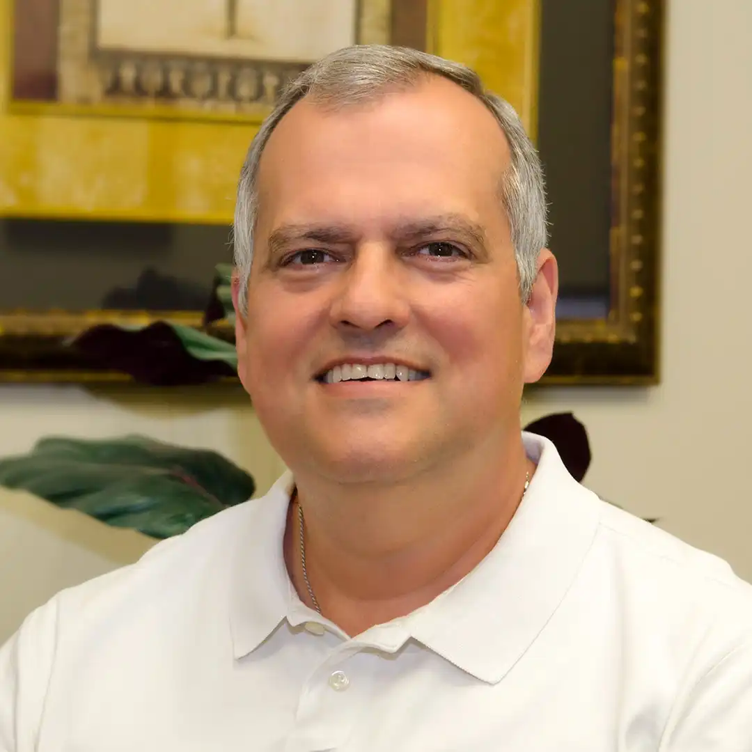 A headshot of Tim McGlothlin while sitting in his office.