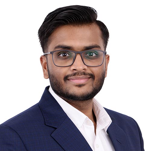 A headshot of Anshul Bansal standing in front of a white background.