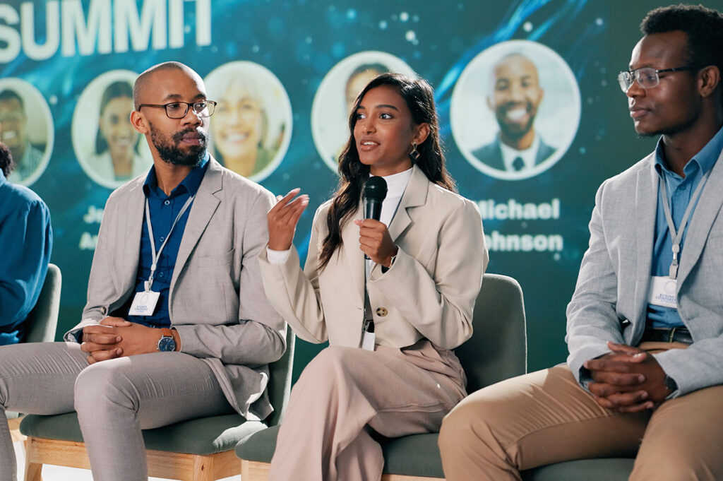 Industry professionals sit on a panel to answer student questions.