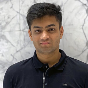 A headshot of Aaradhya Gole standing in front of a white, marbled wall.