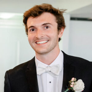 A headshot of Matt Izzo dressed in a tuxedo.