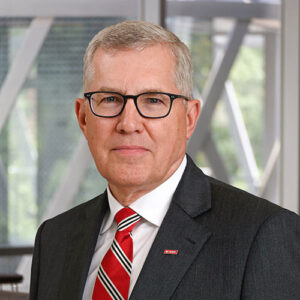 A headshot of Doug Morton standing inf ront of the Talley Student Union building