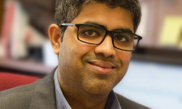A headshot of Rohan Shirwaiker sitting in his office.