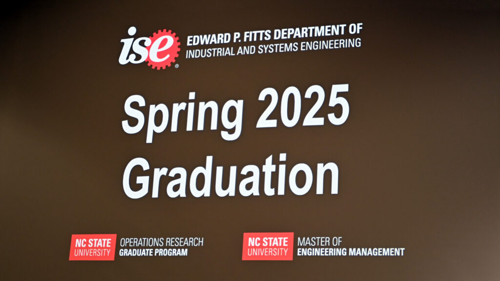 A welcome message to the MEM Spring 2025 Graduation Ceremony shown on a giant screen