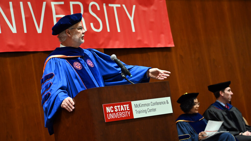 ISE Director of Graduate Programs, Russel King, steps up to the podium to announce each MEM graduate
