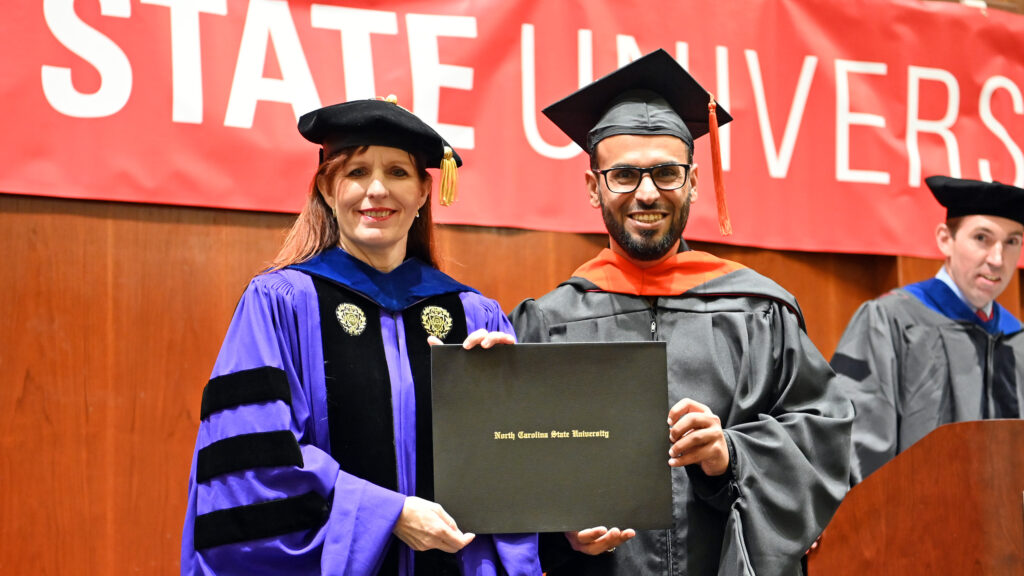 Hamad Alumansour poses with Julie Swann and his degree