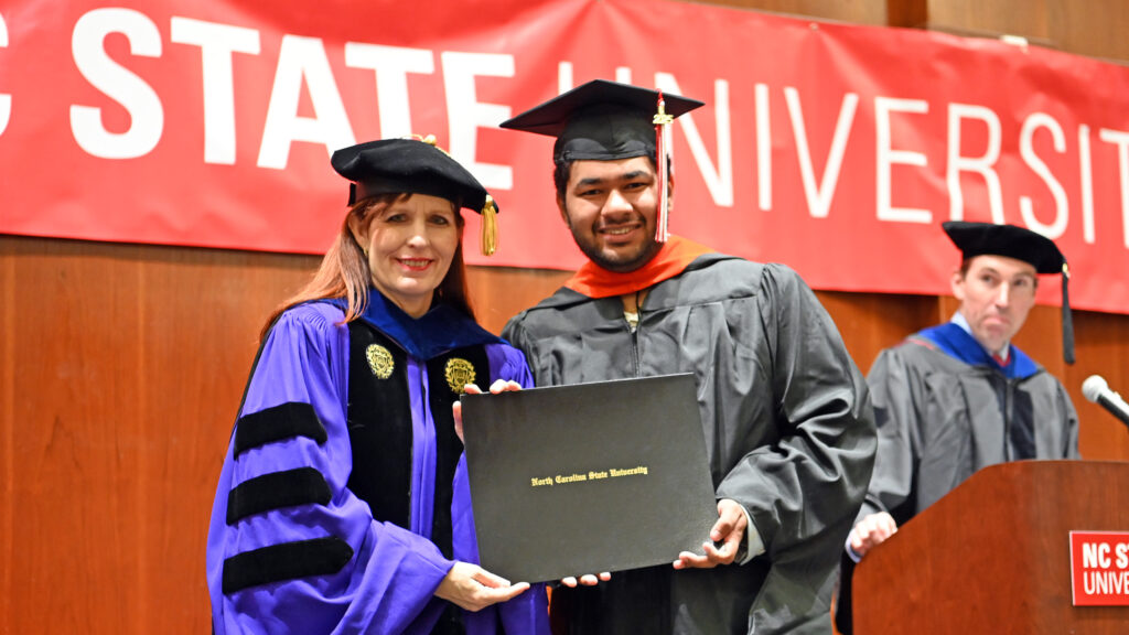 Tarun Asrani poses with Julie Swann and his degree