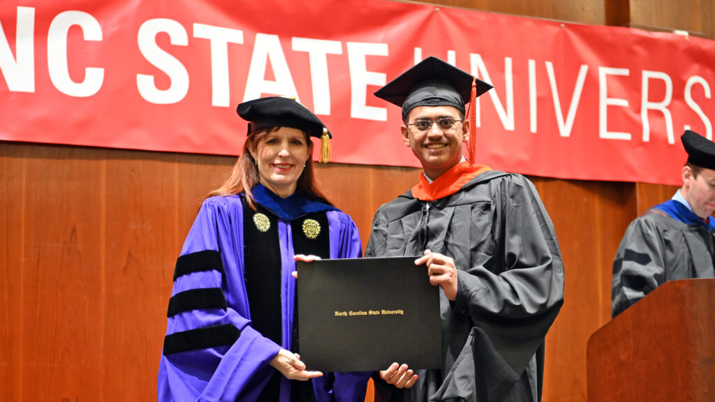 Jatin Chaudhari receives his degree from Julie Swann
