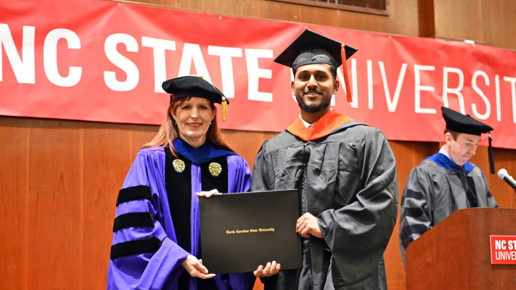 Vighnesh Chavan poses with Julie Swann and his degree