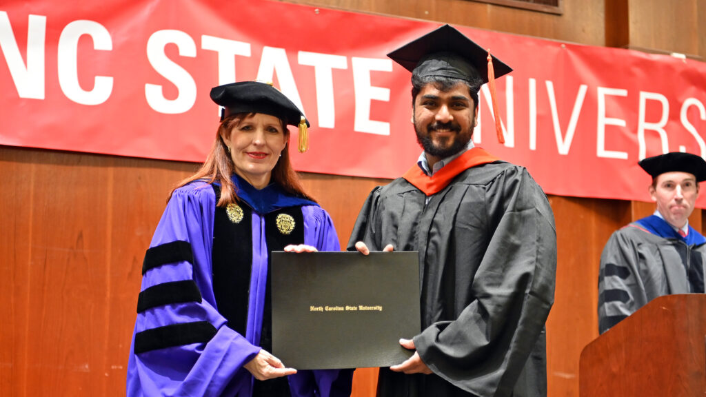 Vidhyudh Ganesh receives his degree from Julie Swann