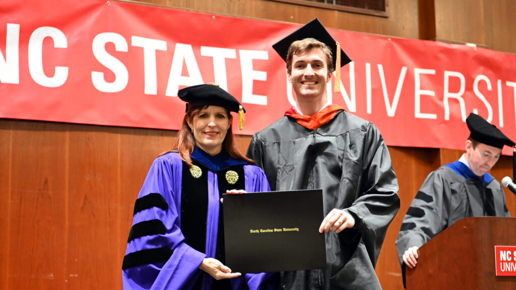 Matthew Izzo poses with Julie Swann and his degree