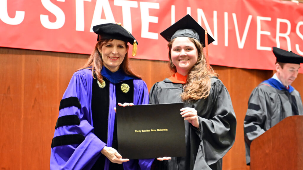Mariel Jeffris receives her degree from Julie Swann