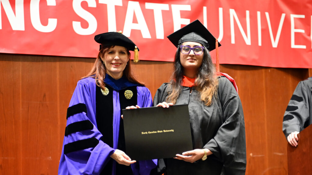 Shubha Jha poses with Julie Swann and her degree
