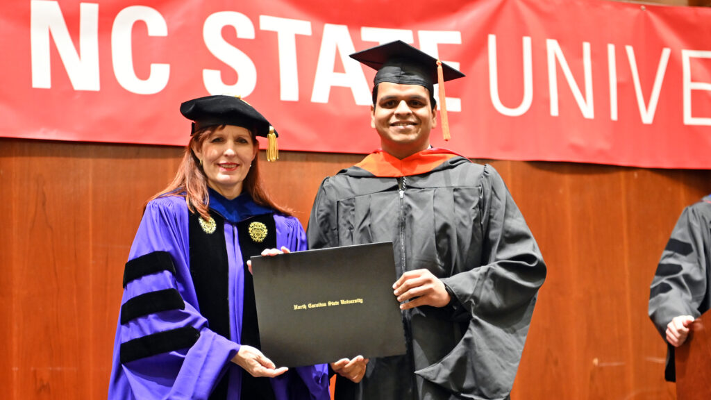 Mrugank Joshi receives his degree from Julie Swann