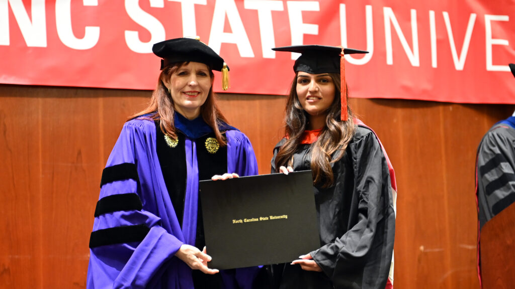 Aakanksha Kelkar poses with Julie Swann and her degree