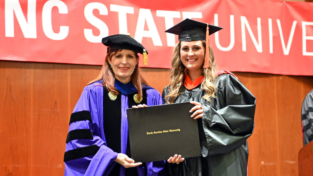 Jaclyn Kenzel receives her degree from Julie Swann