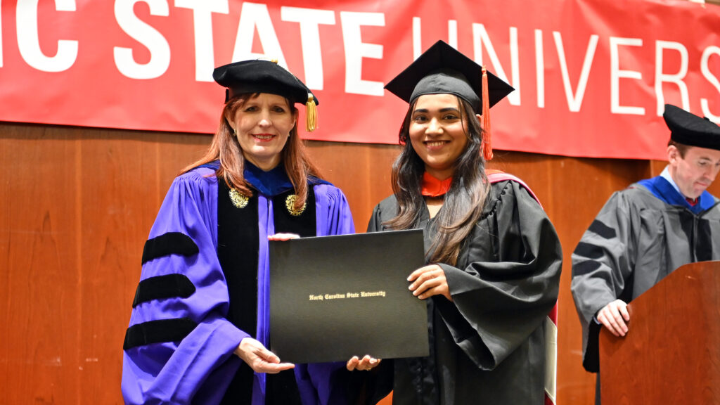 Pranita Khaire poses with Julie Swann and her degree