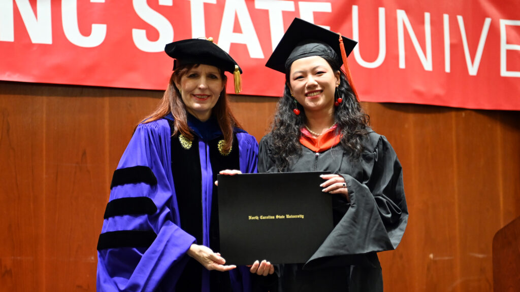 Molly Li poses with Julie Swann and her degree