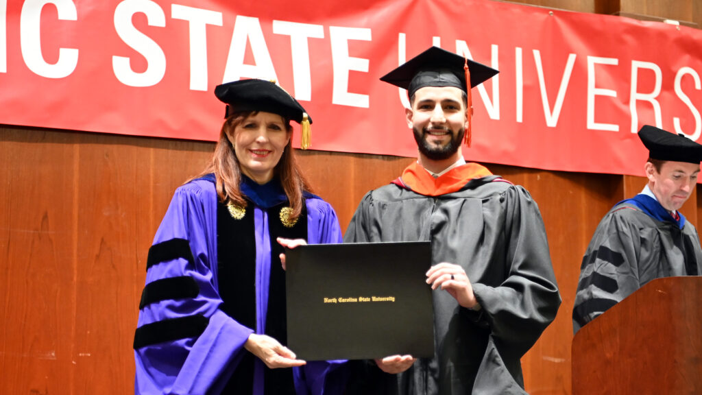 Mohammad Mohammad poses with Julie Swann and his degree