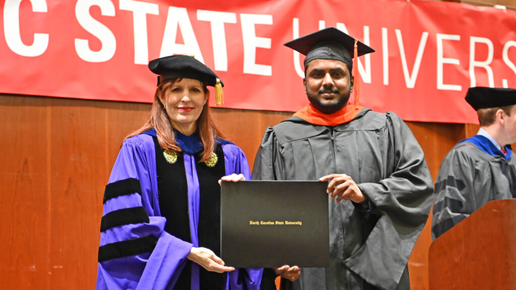 Mubashir Mohammed receives her degree from Julie Swann