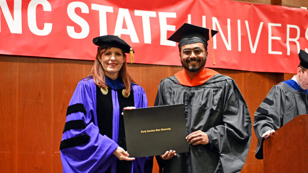 Vrushal Naik receives his degree from Julie Swann