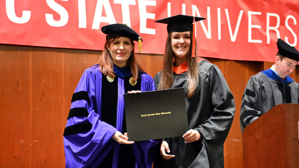 Kaila Park receives her degree from Julie Swann