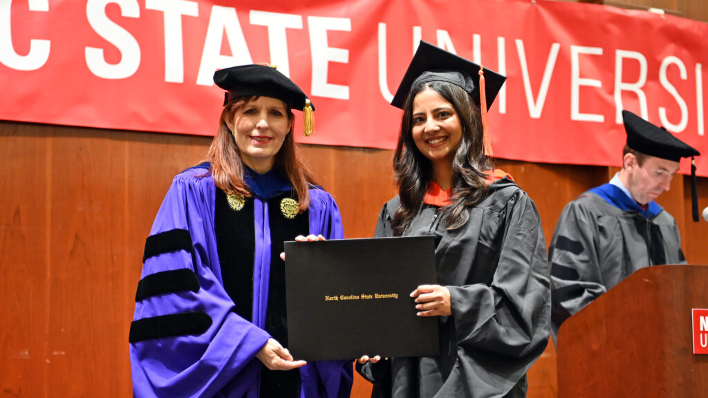 Maitreyi Patil receives her degree from Julie Swann