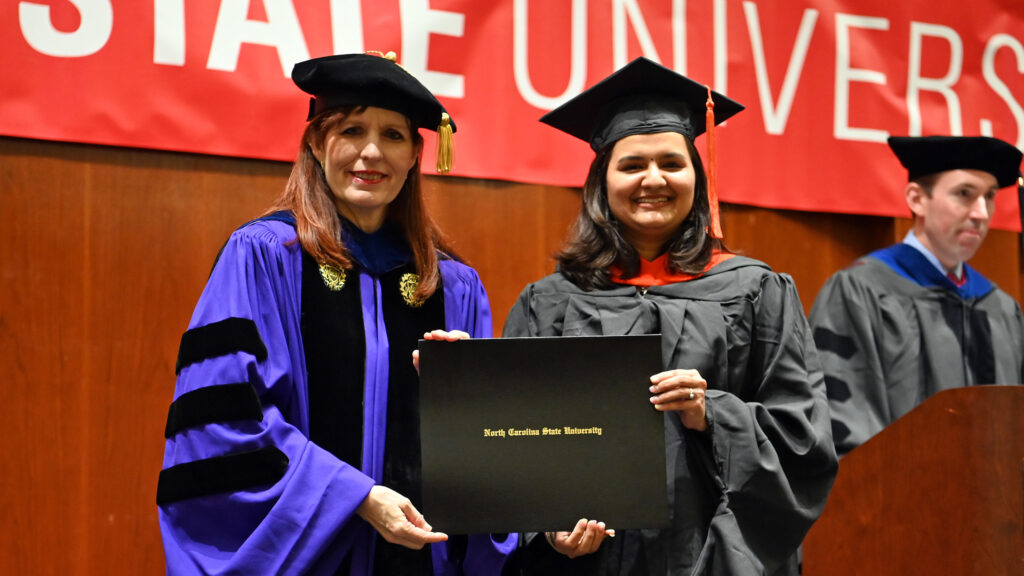 Tanvi Pongde receives her degree from Julie Swann