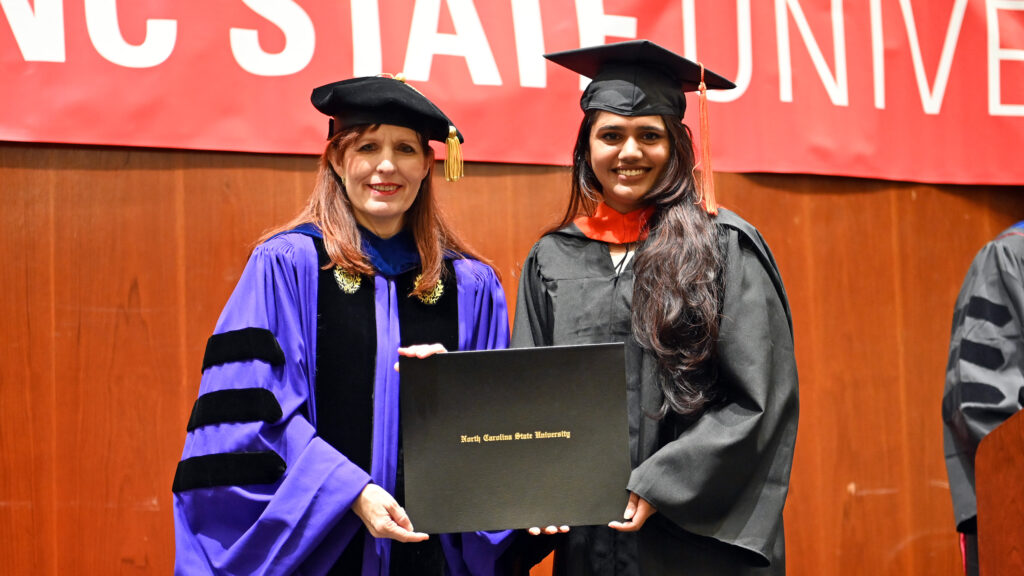 Vyshnavi Pulagam poses with Julie Swann and her degree