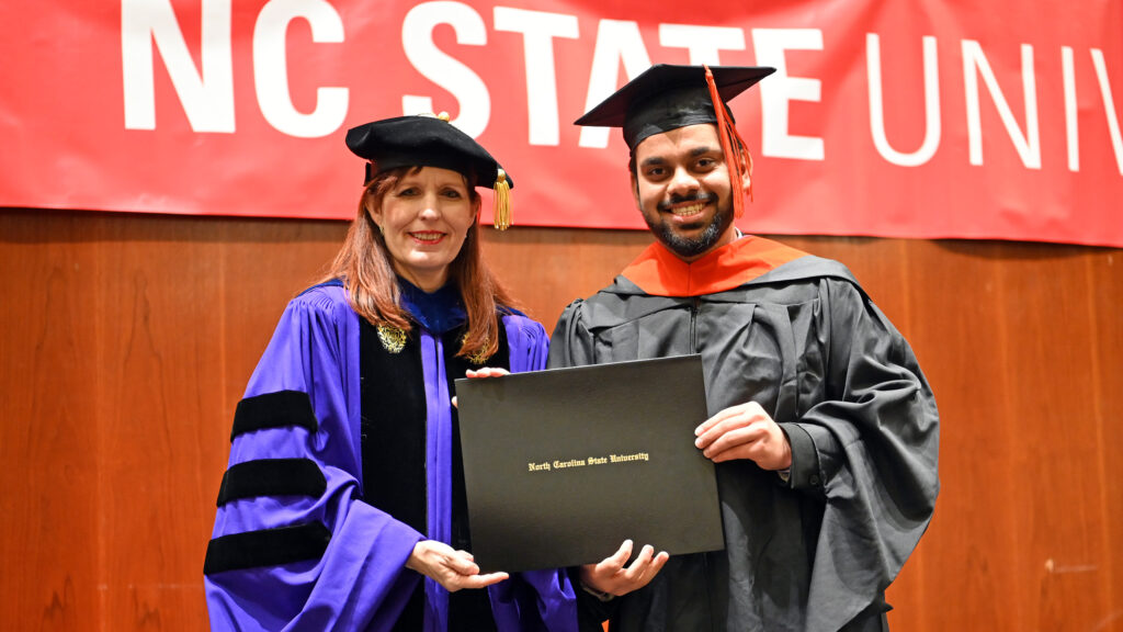 Rhushikesh Shukla poses with Julie Swann and his degree