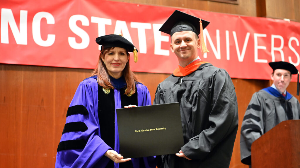 Christian Shuping receives his degree from Julie Swann