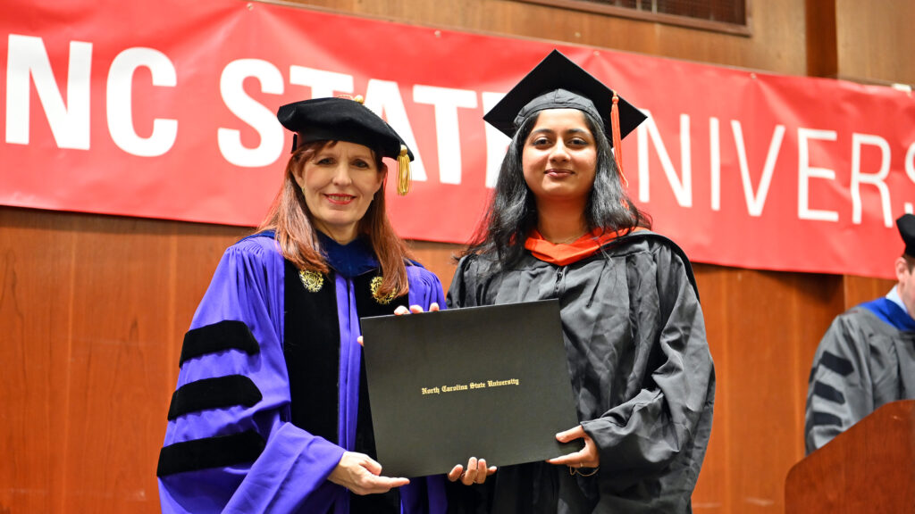 Pooja Sinh poses with Julie Swann and her degree