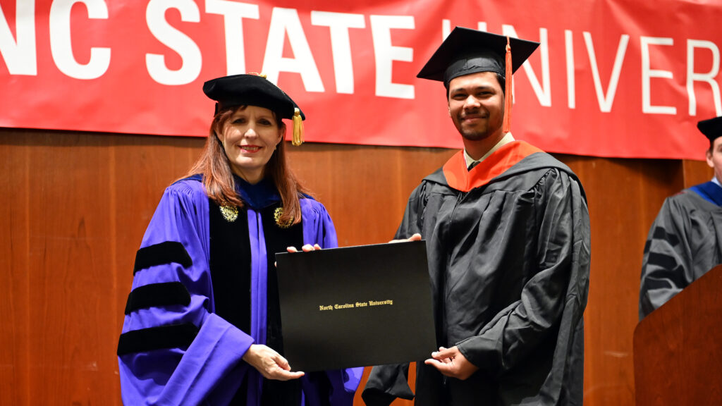 Uttej Tentu receives his degree from Julie Swann