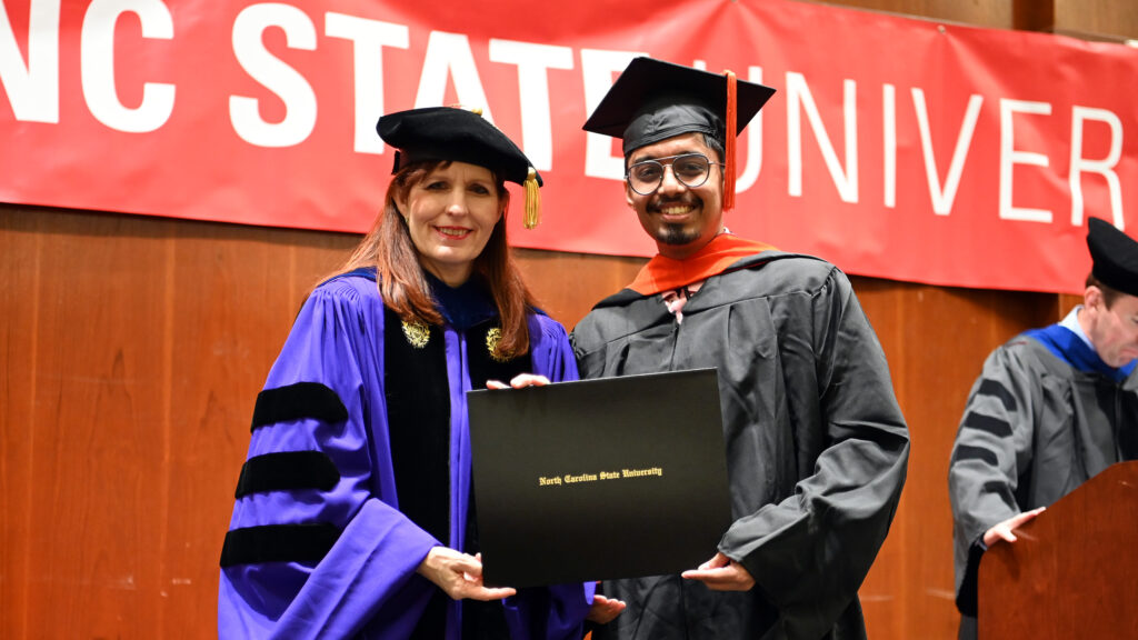 Vipin Varughese poses with Julie Swann and his degree